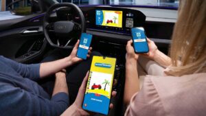 Personer i en bil, der interagerer med smartphones og bilens skærm til et spil.