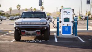 Elbil oplader ved EVgo ladestation i solrige omgivelser