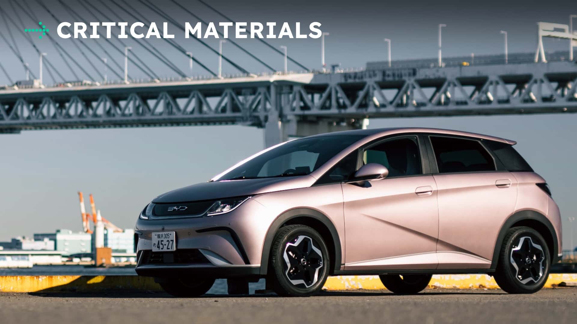 Elektrisk bil foran bro med teksten 'Critical Materials'