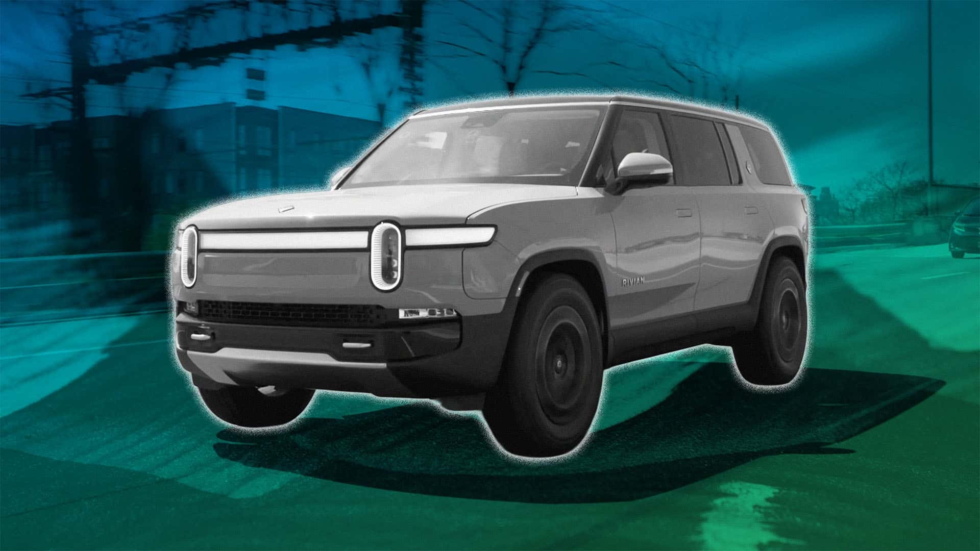 Elektrisk SUV kører på en urban vej med moderne bygninger i baggrunden