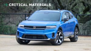 Blå elektrisk SUV med skiltet 'CRITICAL MATERIALS' i baggrunden