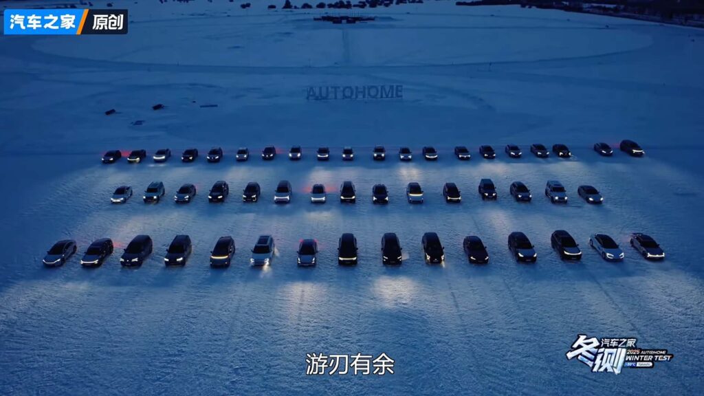 Række af Tesla-biler opstillet i sneen med lyset tændt under vintertest