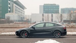 Sort Tesla elbil parkeret i bymiljø om vinteren