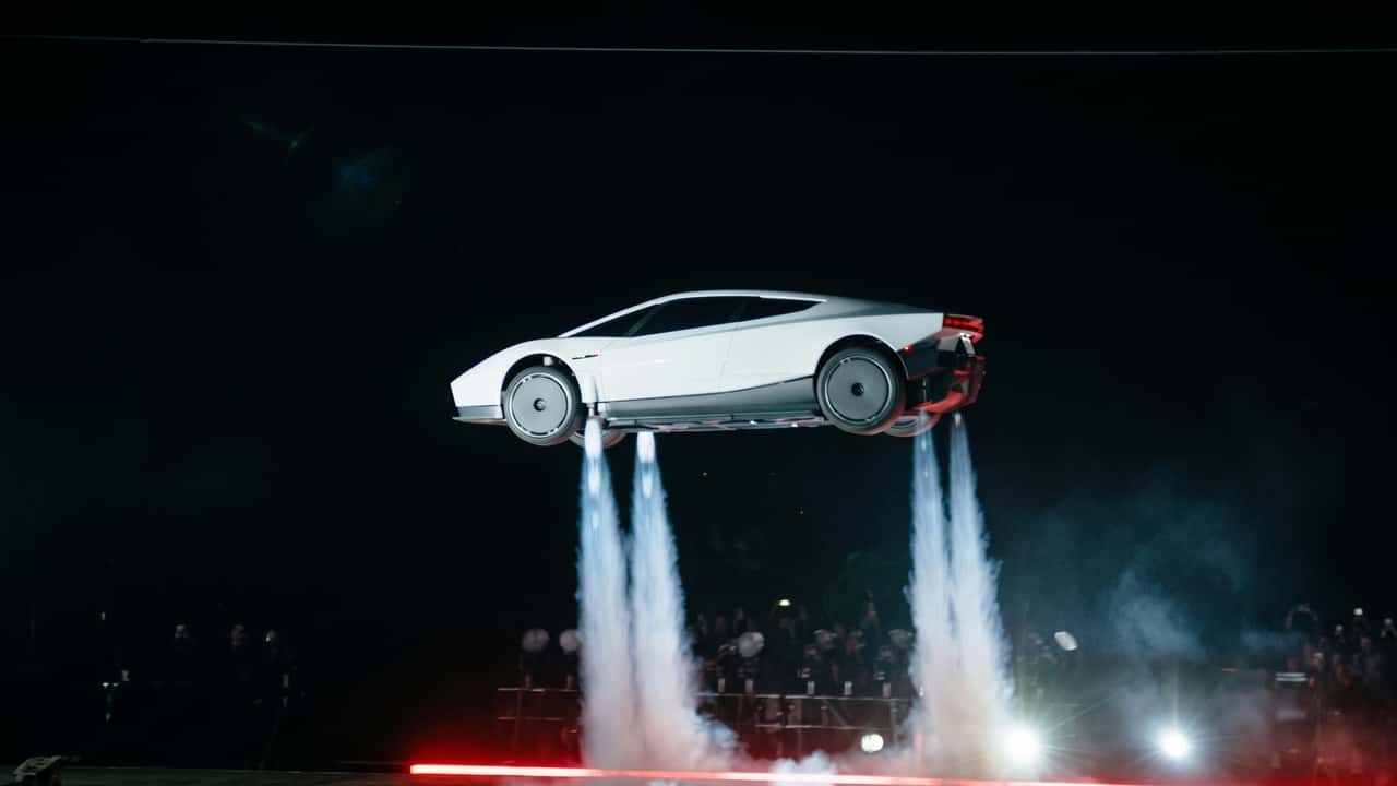 Futuristisk elektrisk bil flyver med jetstråler om natten